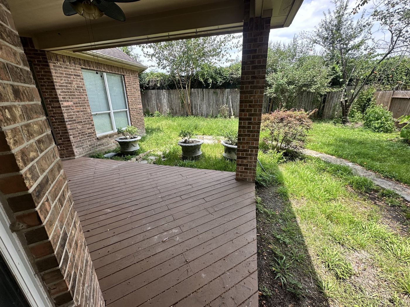 Covered back patio and deck cleared of furniture