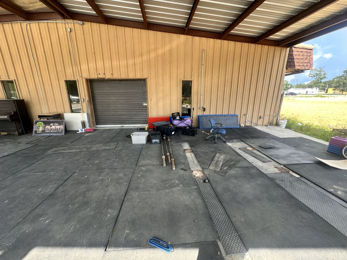 Before: a covered commercial lot with equipment, bins and leftovers