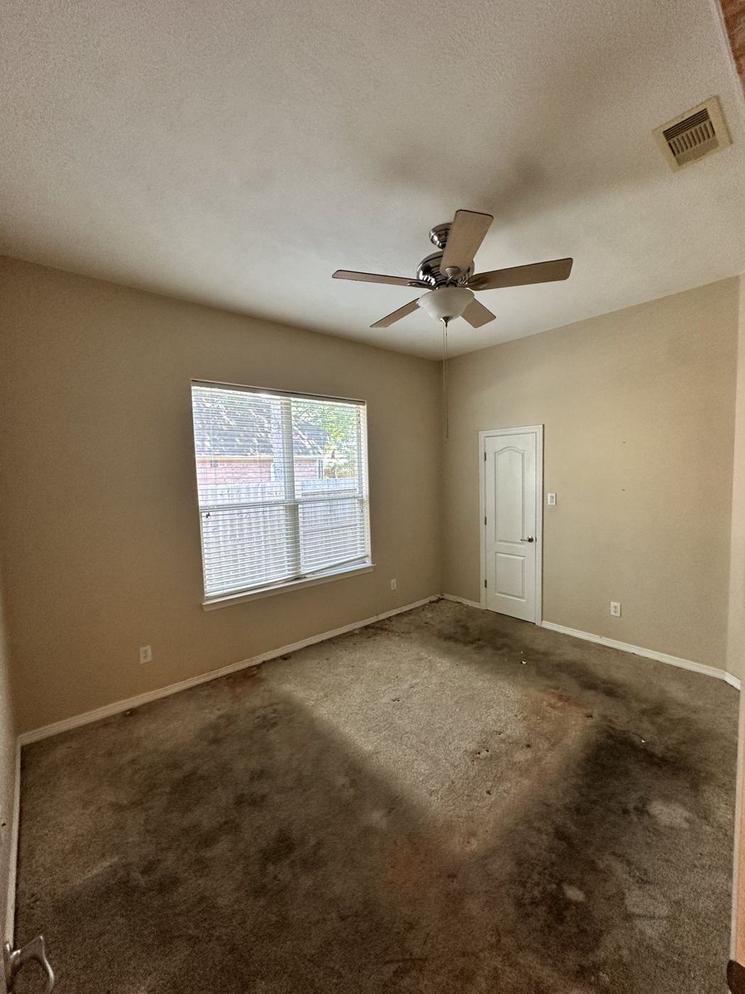 Bedroom emptied down to the carpet after a cleanout