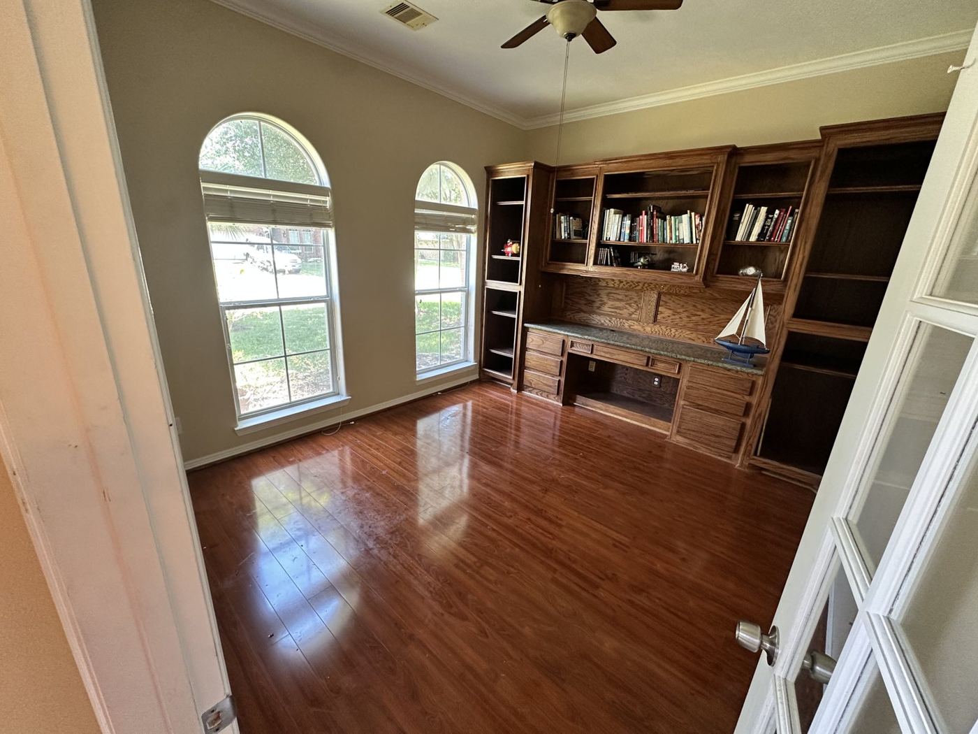 Room cleared out, wood floor and built-in bookshelves left clean