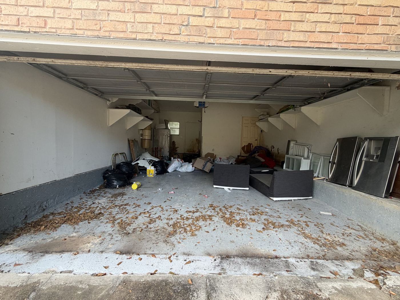 Before: a garage packed with boxes, bags, furniture and household items