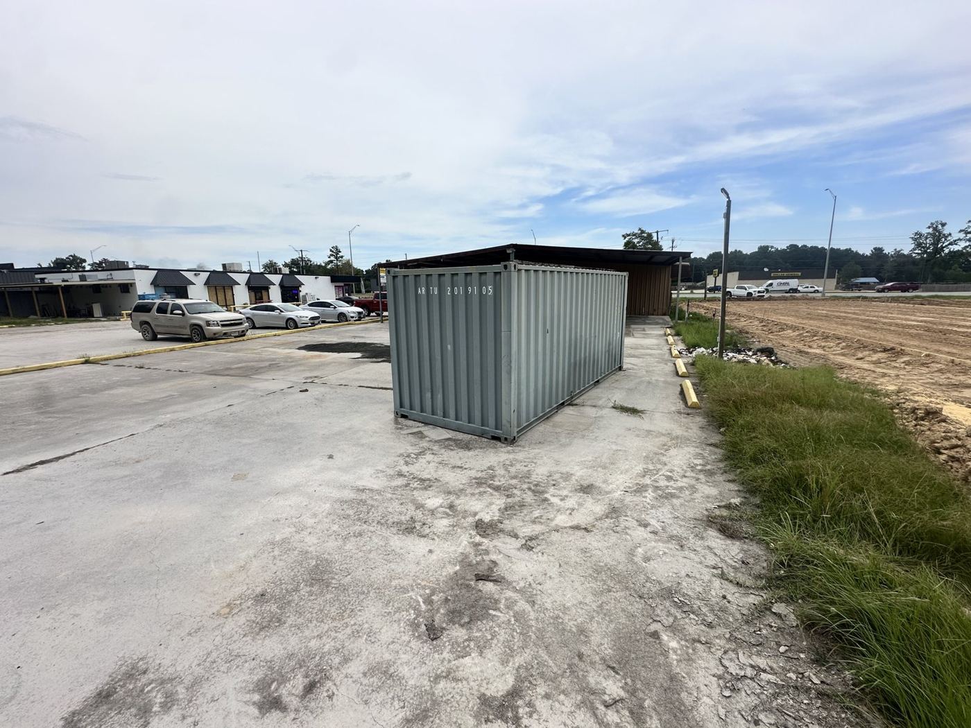 Storage container and cleared pavement on a commercial property